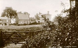 Looking over a gate to a historic photo of a house